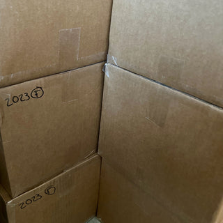 Stack of cardboard boxes with dates on them